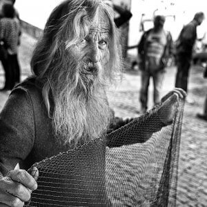 Bird Market, Porto Portugal. Old man selling bird catching net.