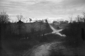 Crossroads with a car at dusk. Indiana USA