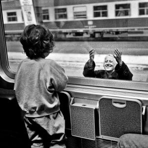 Grandmother and grandson through a t rain window. Hungary.