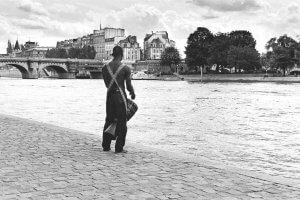African drummer with the river Seine - Paris, France