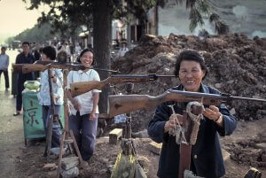 Women with street shooting gallery booth. Nanning China 1984.