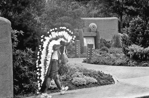 Man carrying ceremonial Native headdress. Santa Fe New Mexico