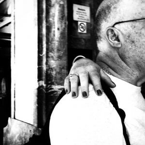 Surreal man with dismembered looking hand on his shoulder.. Porto Portugal.